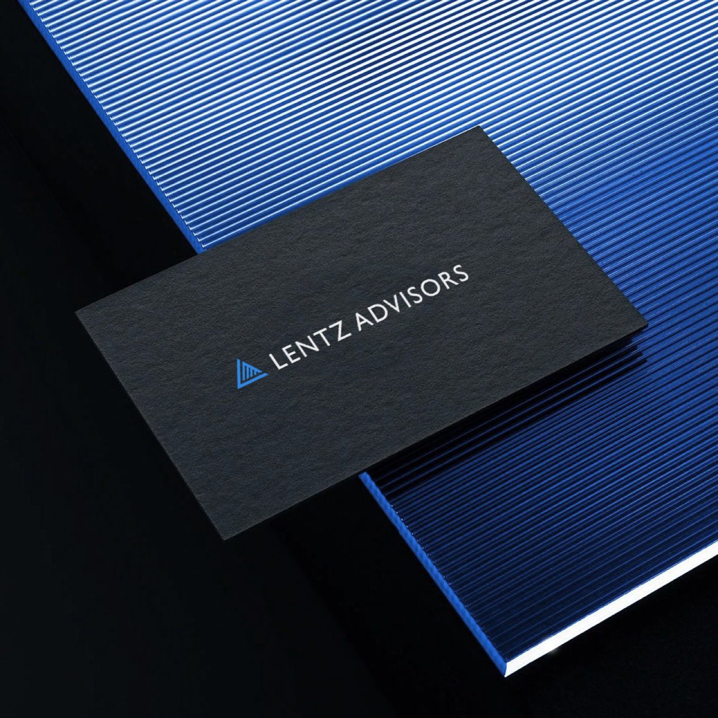 Lentz Advisors business card mockup on a striped blue book